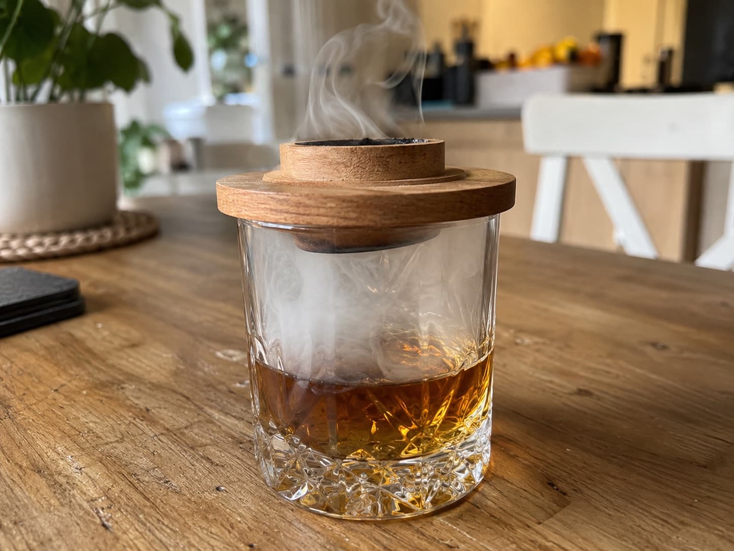 Smoke lid on a tumbler of whisky, with smoke filling the glass above the whisky